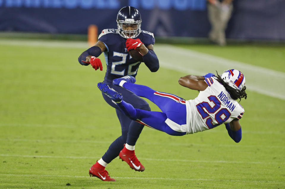 Tennessee Titans running back Derrick Henry (22) knocks down Buffalo Bills cornerback Josh Norman (29) (AP Photo/Wade Payne)