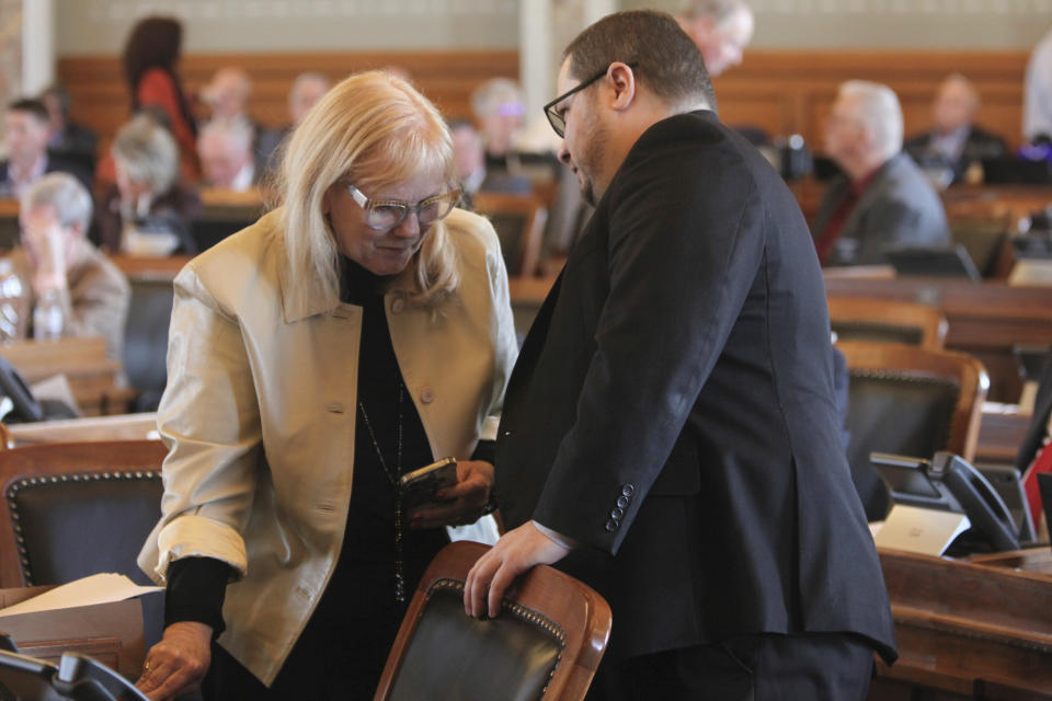 Kansas state Reps. Susan Concannon, right, R-Beloit, and Nick Hoheisel, left, R-Wichita, confer during the House's session, Monday, March 25, 2024, at the Statehouse in Topeka, Kan. The Kansas House began in 2024 to list the names of interest groups and lobbyists seeking legislation on the bills and resolutions themselves. (AP Photo/John Hanna)