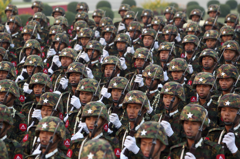 FILE - In this March 27, 2019, file photo, Myanmar military officers march during a parade to mark the 74th Armed Forces Day in Naypyitaw, Myanmar. A United Nations fact-finding mission is calling for an embargo on arms sales to Myanmar and targeted sanctions against businesses with connections to the military that it says are helping fund human rights abuses, report released Monday, Aug. 5, 2019. (AP Photo/Aung Shine Oo, File)