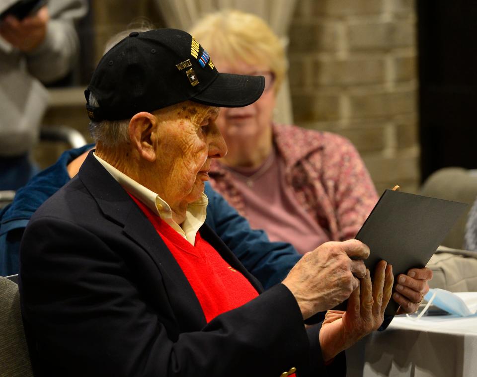 A event was held at the 1881 Event Hall in Spartanburg to honor the military service of four World War II veterans.  George Reitmeier of the U.S. Army shows one of his awards.