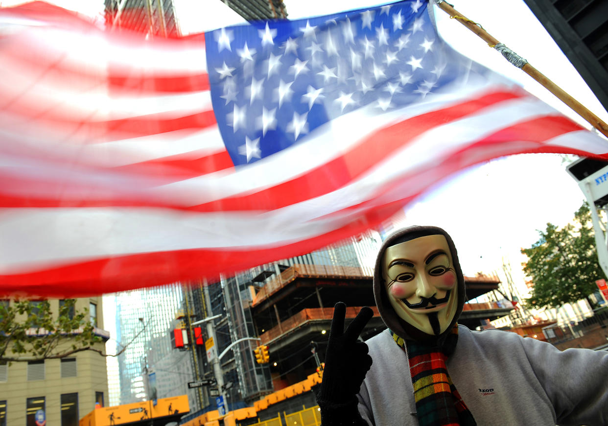 Occupy Wall Street protester Guy Fawkes with American flag at Zuccotti Park, (Photo By: Robert Sabo/NY Daily News via Getty Images)