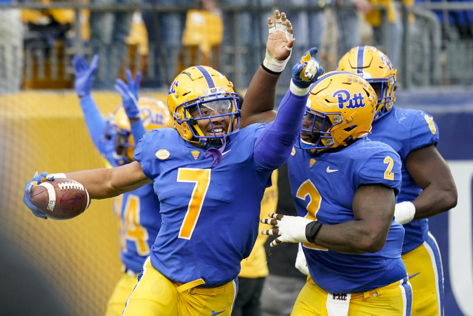 Pittsburgh linebacker SirVocea Dennis (7) celebrates with defensive lineman David Green (2) after returning an interception for a touchdown against Clemson during the second half of an NCAA college football game, Saturday, Oct. 23, 2021, in Pittsburgh. Pittsburgh won 27-17. (AP Photo/Keith Srakocic)