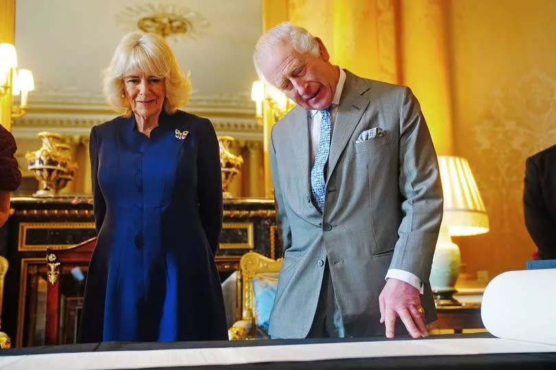 King Charles III and Queen Camilla are presented with the Coronation Roll, an official record of their Coronation