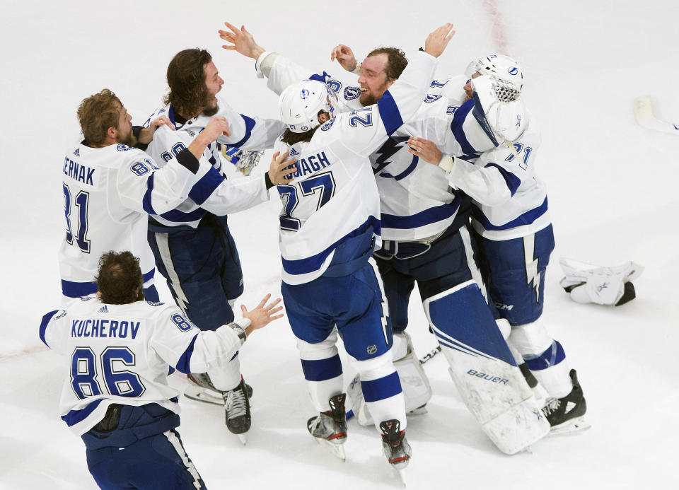 Tampa Bay Lightning players celebrate after defeating the Dallas Stars to win the Stanley Cup in Edmonton, Alberta, on Monday, Sept. 28, 2020. (Jason Franson/The Canadian Press via AP)