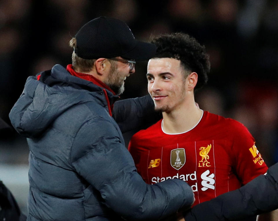 Liverpool's Curtis Jones (right) is congratulated by manager Jurgen Klopp after Jones' first senior goal beat Everton in Sunday's FA Cup third-round match at Anfield. (Reuters/Phil Noble)