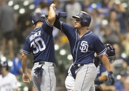 Aug 7, 2018; Milwaukee, WI, USA; San Diego Padres left fielder Hunter Renfroe (10) high fives first baseman Eric Hosmer (30) after hitting a home run during the eighth inning against the Milwaukee Brewers at Miller Park. Mandatory Credit: Jeff Hanisch-USA TODAY Sports