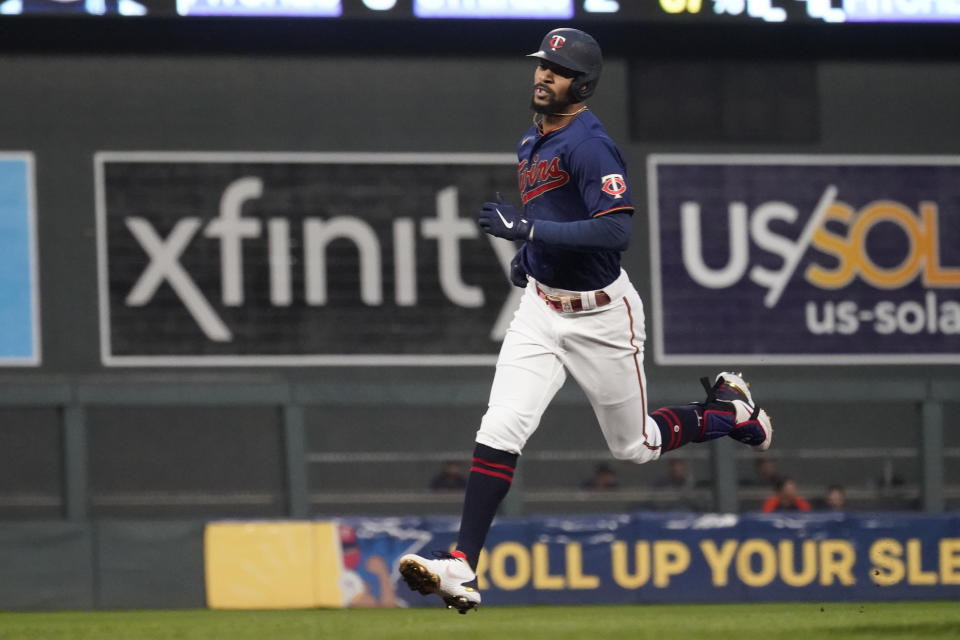 Minnesota Twins' Byron Buxton, right, rounds the bases on a solo home run off Detroit Tigers pitcher Tarik Skubal in the first inning of a baseball game, Thursday, Sept. 30, 2021, in Minneapolis. (AP Photo/Jim Mone)