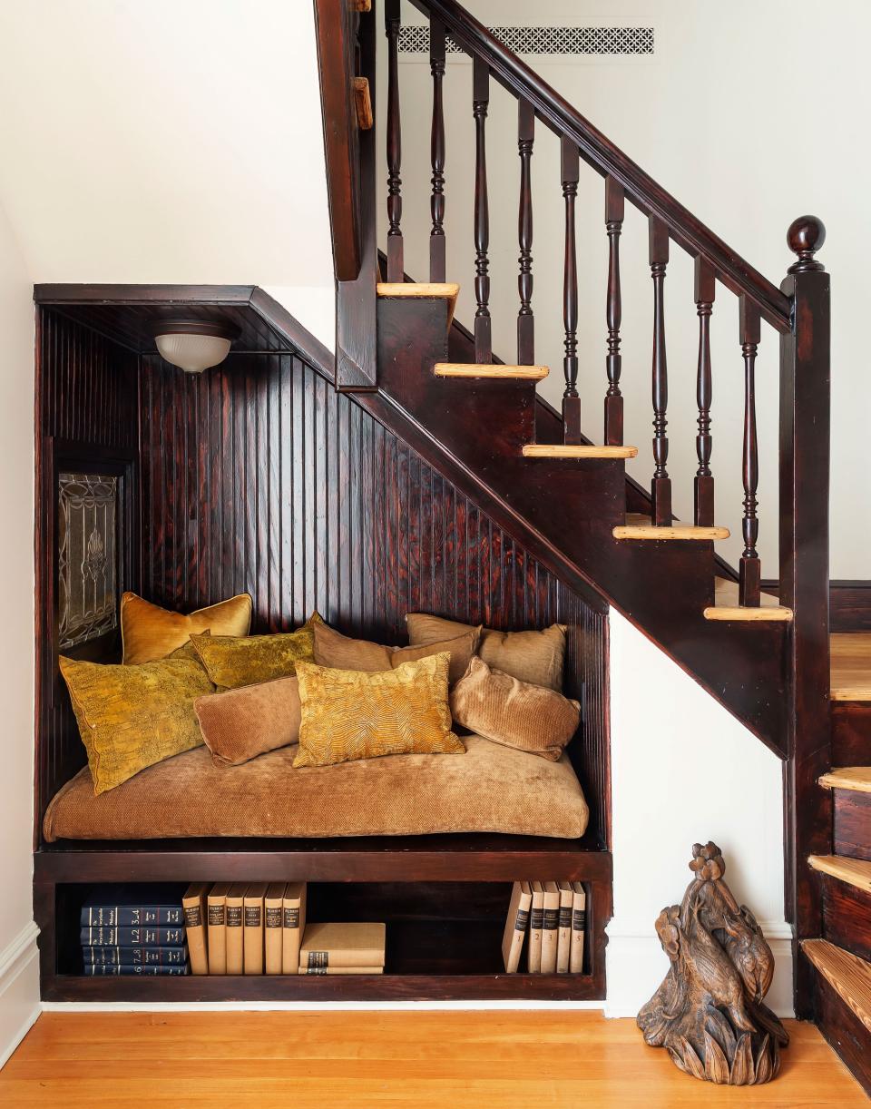 A cozy nook makes for the perfect perch underneath an interior staircase.