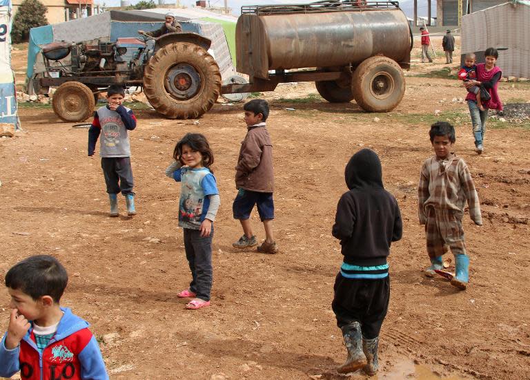 Syrian children play at a refugee camp on the outskirts of the eastern Lebanese city of Baalbek on February 24, 2015