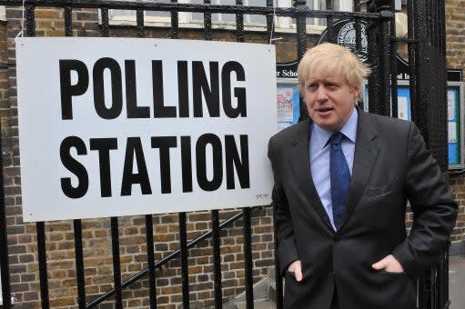 <p>Boris Johnson stands outside a polling station in Islington, north London, after casting his ballot in the 2010 general election while serving as the capital’s mayor</p> (PA)