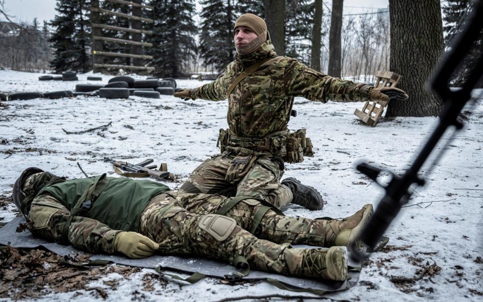 An instructor teaches Ukrainian volunteers during basic training for its 3rd Separate Assault Brigade