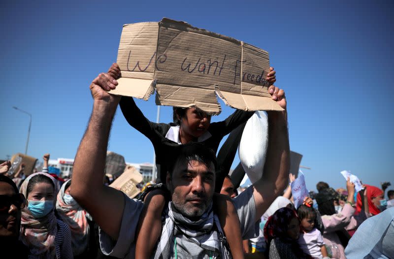 Refugees and migrants from the destroyed Moria camp protest on the island of Lesbos