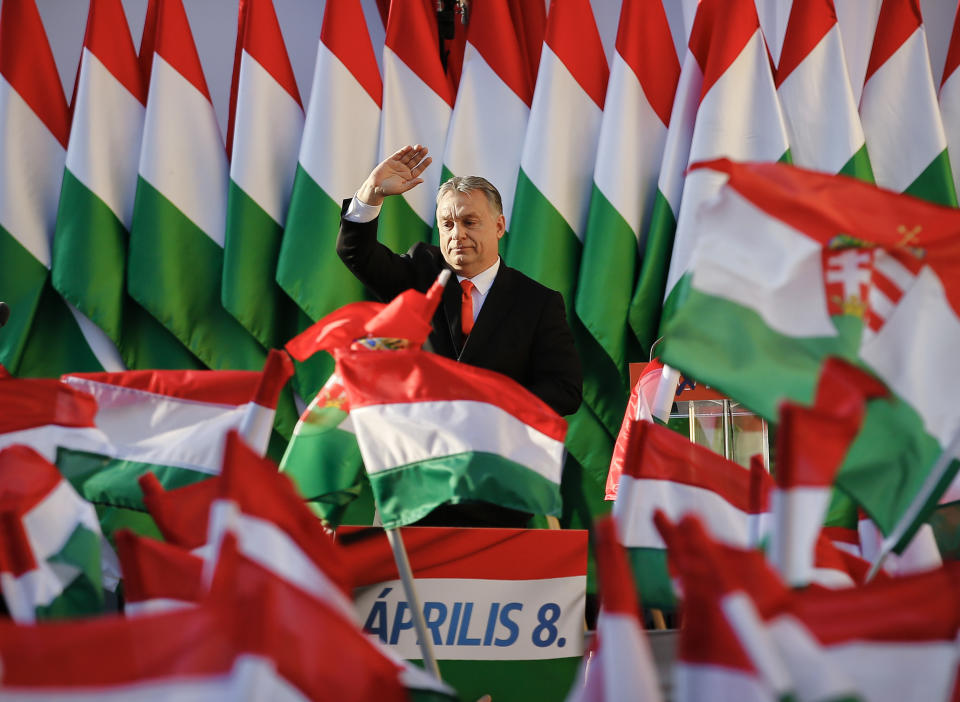 FILE - In this Friday, April 6, 2018 file photo, Prime Minister Viktor Orban waves during the final electoral rally of his Fidesz party in Szekesfehervar, Hungary. After a landslide 2018 election victory, Orban talks about Hungary’s “system of national cooperation,” a process that has hobbled the court system, re-written the constitution and given immense power to himself and his party. (AP Photo/Darko Vojinovic, File)