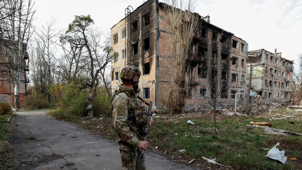 A Ukrainian soldier looks at destroyed buildings in Avdiivka, eastern Ukraine. File photo