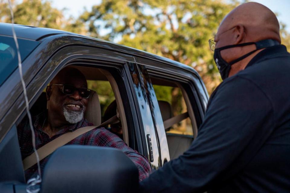 Larry Stewart, Chairman of the Deacons’ Ministry at Handsboro Baptist Church, greets Pastor Seymour Venson Adolph, Jr. during a parade for Adoph’s retirement at Handsboro Baptist Church in Gulfport on Saturday, Dec. 4, 2021.