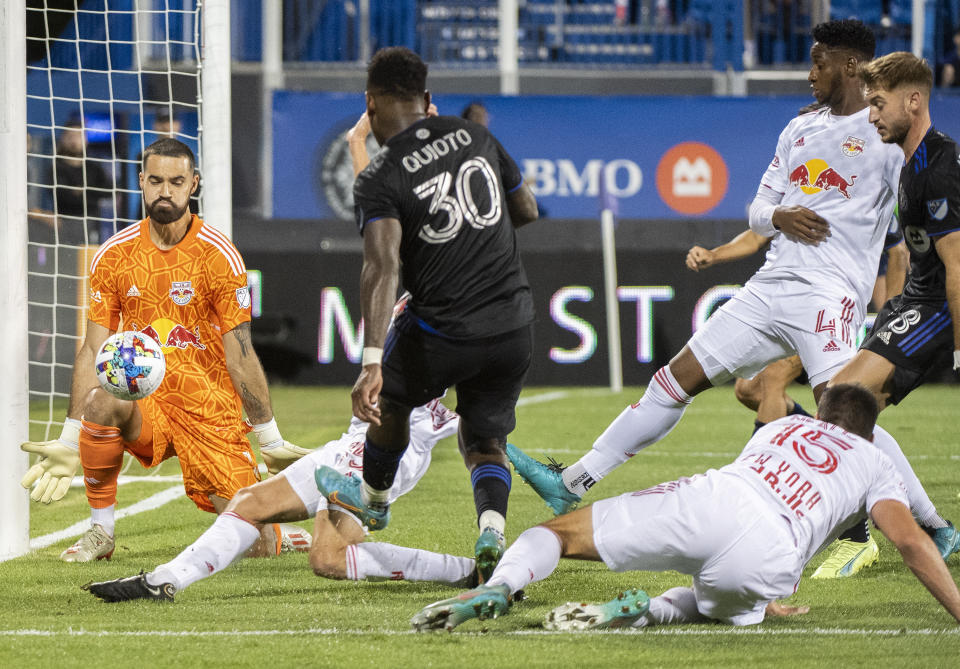 CF Montreal's Romell Quioto (30) takes a shot on New York Red Bulls goalkeeper Carlos Coronel during the first half of an MLS soccer match Wednesday, Aug. 31, 2022, in Montreal. (Graham Hughes/The Canadian Press via AP)