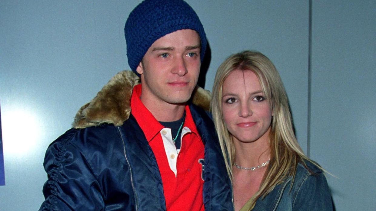 britney spears and justin timberlake standing together and embracing for a photo