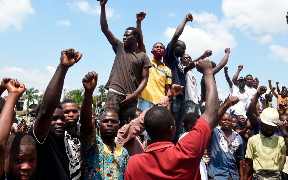 Protesters chant and sing solidarity songs as they barricade barricade the Lagos-Ibadan expressway  - AFP