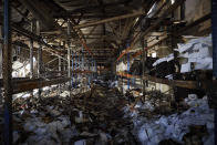 Burnt books are seen in a damaged workshop of Ukraine's largest printing house, ruined in Thursday deadly Russian missile attack that killed seven civilians in Kharkiv, Ukraine, Friday, May 24, 2024. (Ukrainian Presidential Press Office via AP)