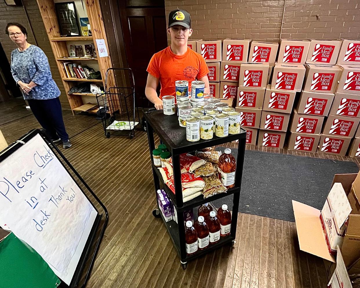 Boy Scout Troop 40 member Tyler Nolette volunteers at the Matthew Mission food pantry in Taunton on Saturday, March 16, 2024.