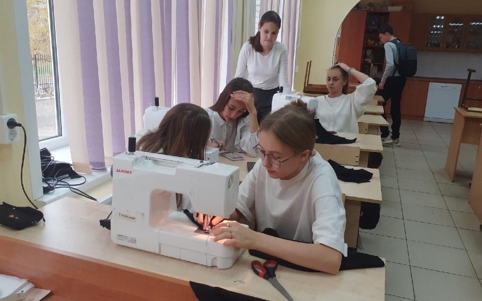 The school posted photos of the girls hunched over sewing machines