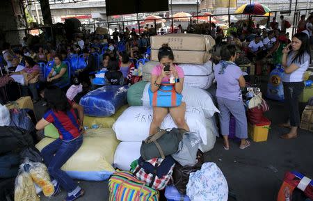 Stranded passengers guard their belongings while waiting at a bus terminal in Manila May 9, 2015. REUTERS/Romeo Ranoco