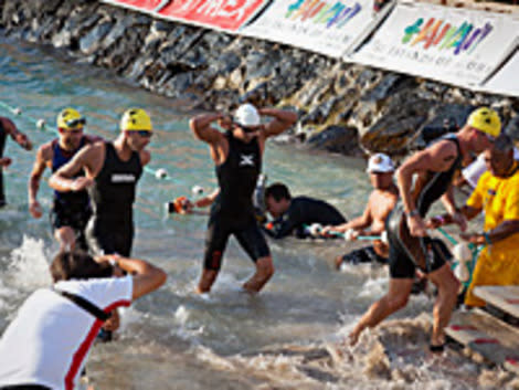 Luke Bell, leads triathletes exiting the water after the 2.4 mile swim portion of the Ford Ironman World Championship on Oct. 8, 2011 in Kailua-Kona, Hawaii.