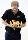 <p>In a playful moment with the Australian team, Harry pretends to kick a cuddly kangaroo toy (the team's "mascot.") "I thought he was going to punt it into the pool for a second," competitor Chris Clark tells PEOPLE. "He has a good sense of humor."</p>