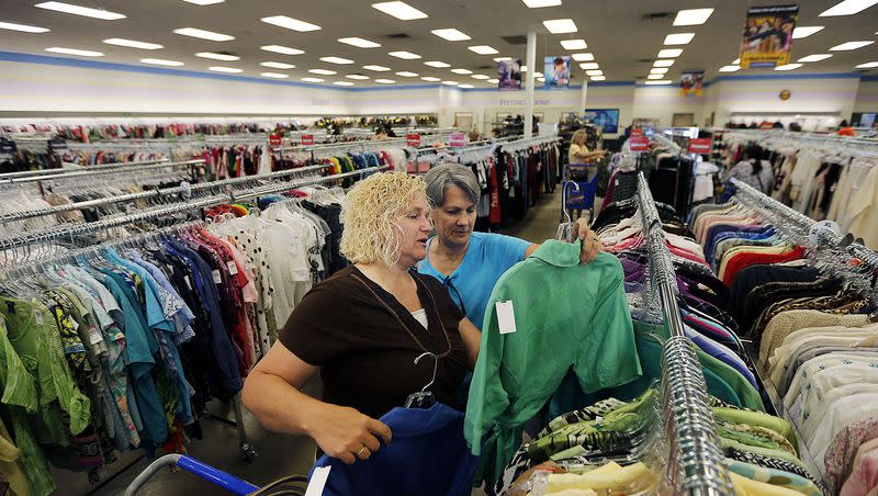 Marian Robinson, front, and Sharon Porter look at clothing during the grand opening for the Layton Easter Seals-Goodwill store on July 16, 2015.