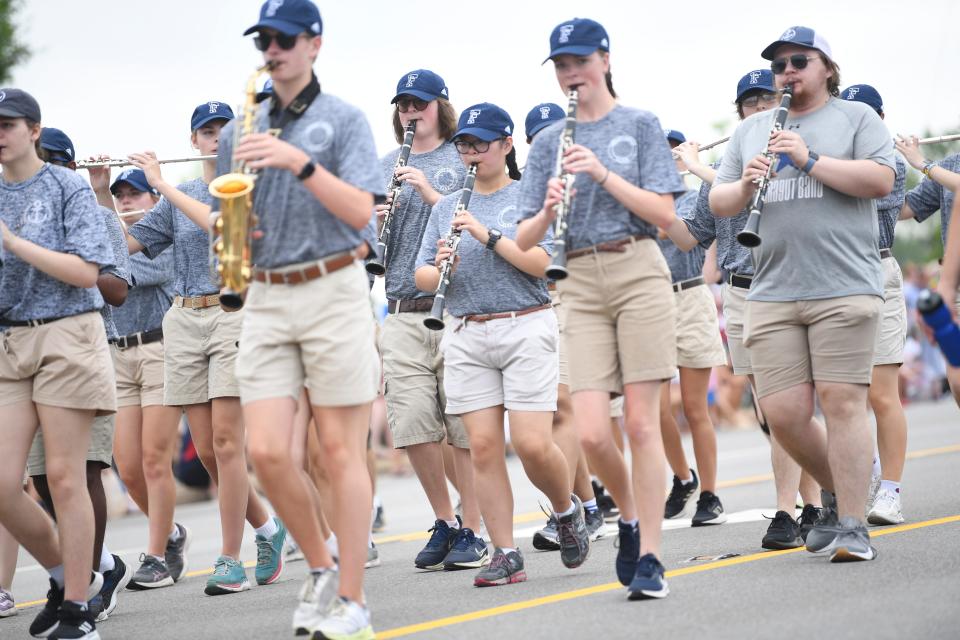 The Farragut band and alumni march in the Farragut Independence Day Parade on Kingston Pike, Tuesday, July 4, 2023.