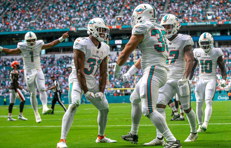 Miami Dolphins Raheem Mostert (31) celebrates with his teammate fullback Alec Ingold (30), after Ingold scored a touchdown on a pass from Miami Dolphins quarterback Tua Tagovailoa (1), left, against the Cleveland Browns during NFL action Sunday November 13, 2022 at Hard Rock Stadium in Miami Gardens.