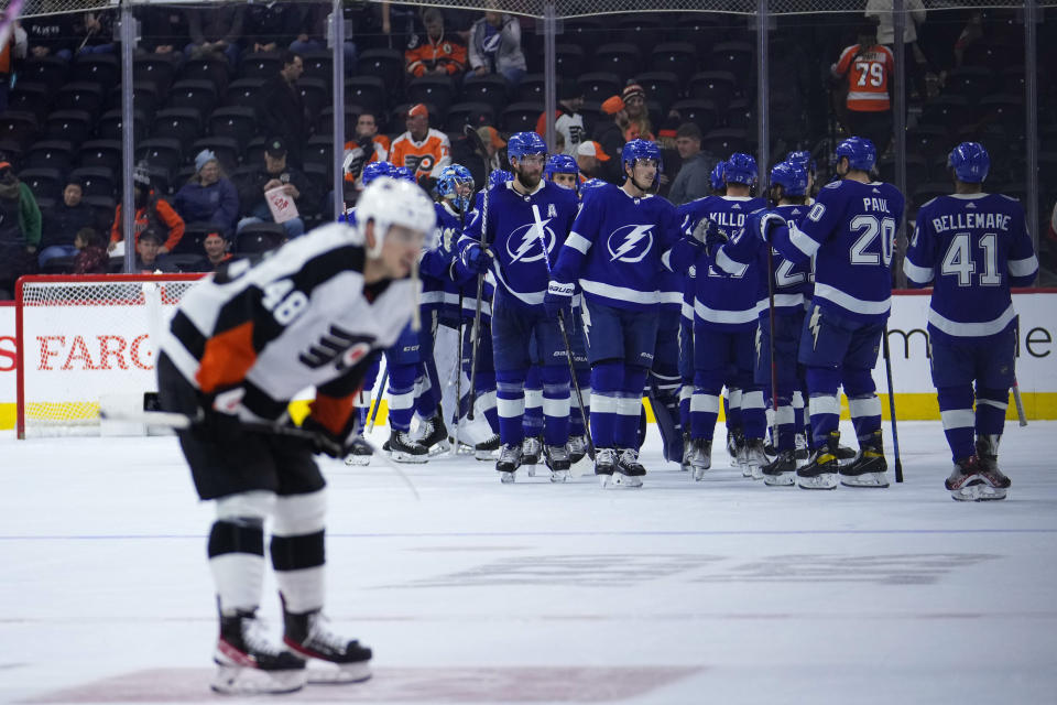 Tampa Bay Lightning players celebrate after an NHL hockey game against the Philadelphia Flyers, Thursday, Dec. 1, 2022, in Philadelphia. (AP Photo/Matt Slocum)