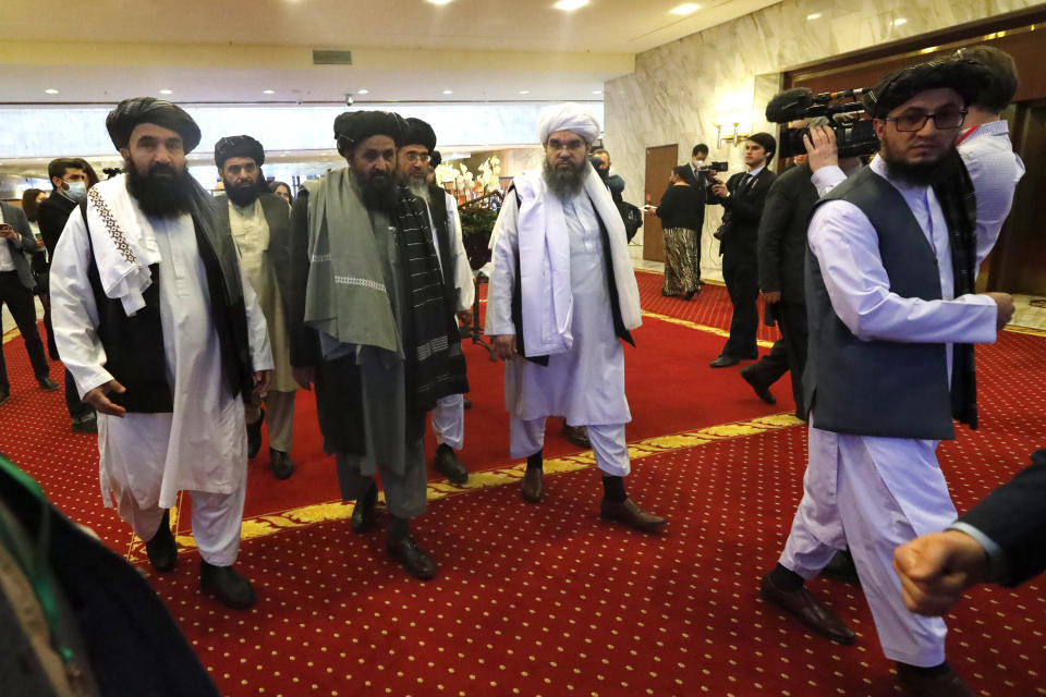 FLE - In this March 18, 2021, file photo, Taliban co-founder Mullah Abdul Ghani Baradar, center, arrives with other members of the Taliban delegation for attending an international peace conference in Moscow, Russia. U.S.-backed Afghan peace meeting postponed, as Taliban balk a conference that Washington expected would move Afghanistan's warring sides to a final peace agreement has been postponed, as fresh violence rattles the Afghan capital, Wednesday, April 21, 2021. (AP Photo/Alexander Zemlianichenko, Pool, File)