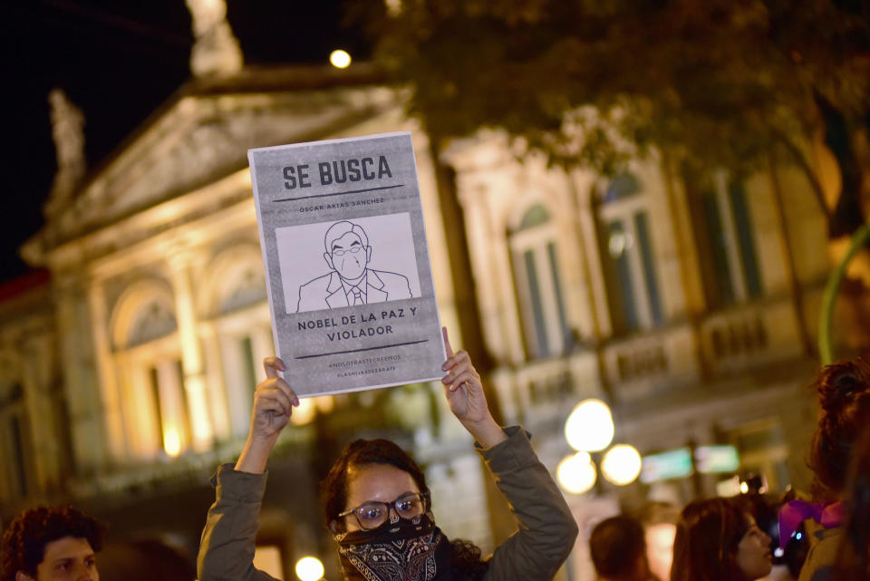 A woman holds up a sign with a line drawing depicting Costa Rica’s ex-President Oscar Arias and a message that reads in Spanish: “WANTED: Oscar Arias Nobel Peace Prize laureate and Violator”, during a protest by women activists under the slogan "Yo te creo," or "I believe you,” in San Jose, Costa Rica, Friday Feb. 8, 2019. At least five women have accused Arias of actions ranging from unwelcome fondling or sexual innuendo to sexual assault. (AP Photo/Carlos Gonzalez)