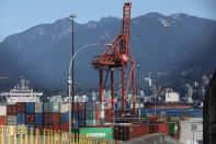 Containers and shipping cranes lie idle at the Port of Vancouver