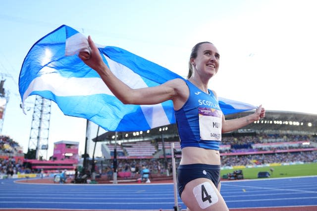 Laura Muir holds up the Scottish flag after finishing a race at the 2022 Commonwealth Games