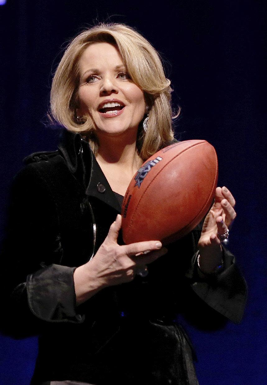 Opera singer Renee Fleming who will sing the National Anthem before the NFL Super Bowl XLVIII football game holds the game ball during a press conference Thursday, Jan. 30, 2014, in New York. (AP Photo)