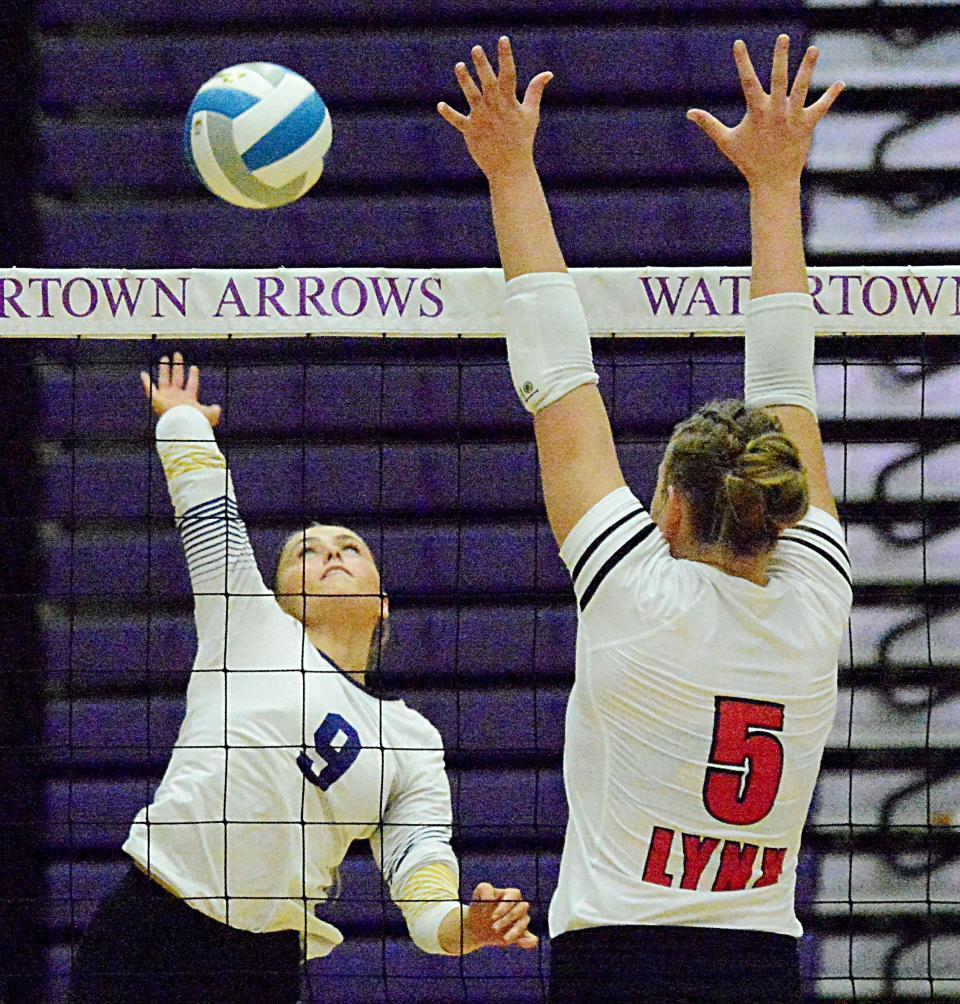 Watertown's Kendall Paulson (9) goes up to spike the ball against Brandon Valley's Josey Wickersham during their Eastern South Dakota Conference volleyball match Thursday night in the Civic Arena. The Arrows won 3-2.