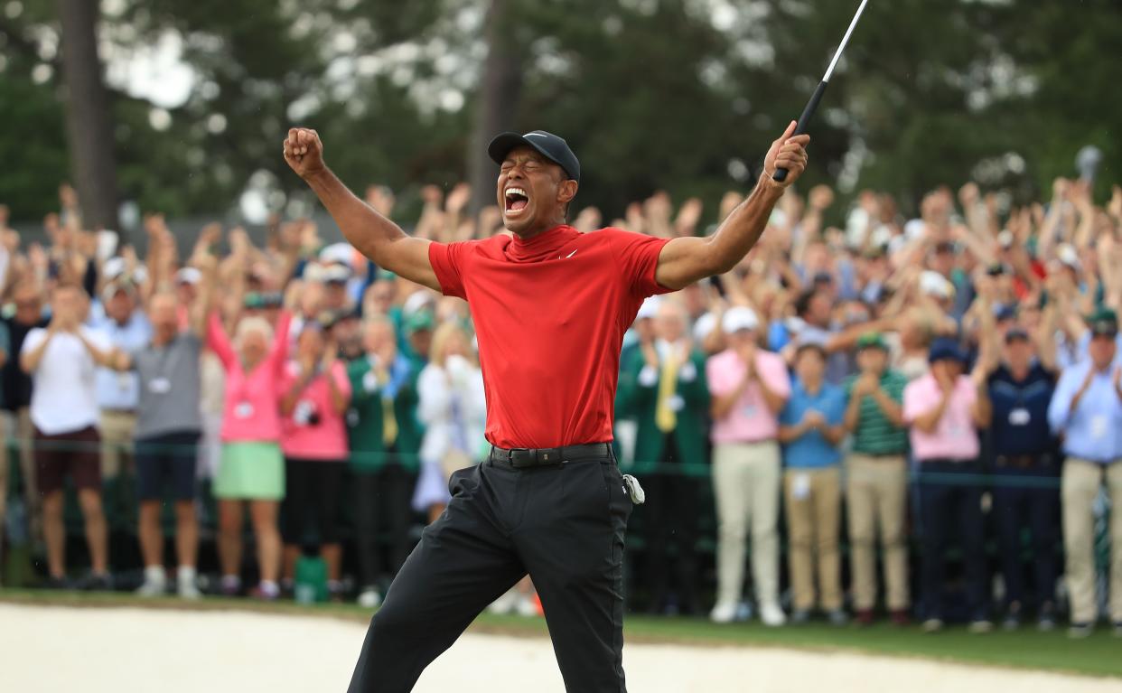 Tiger Woods (L) of the United States celebrates on the 18th green after winning the Masters at Augusta National Golf Club on April 14, 2019 in Augusta, Georgia.