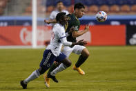 Portland Timbers forward Felipe Mora, right, and Vancouver Whitecaps midfielder Janio Bikel, left, battle for the ball in the first half during an MLS soccer game Sunday, April 18, 2021, in Sandy, Utah. (AP Photo/Rick Bowmer)