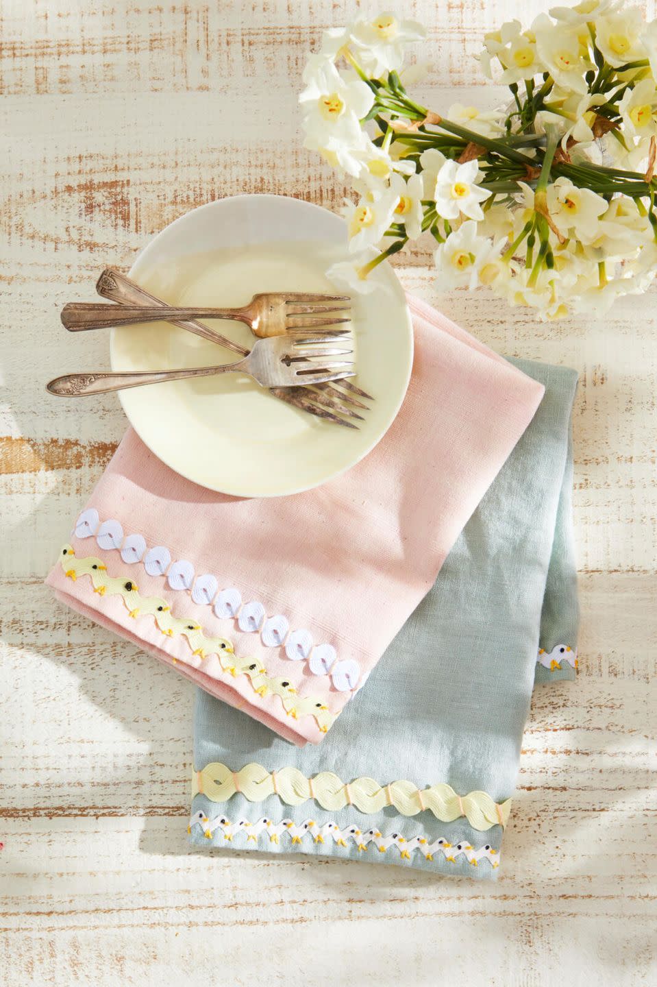 pastel napkins with a rick rack trim that is decorated to look like chicks and eggs