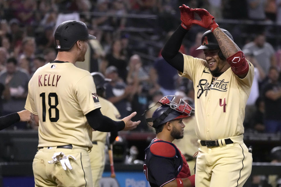 Arizona Diamondbacks' Ketel Marte celebrates with Carson Kelly (18) after hitting a three-run home run against the Washington Nationals during the third inning of a baseball game Friday, July 22, 2022, in Phoenix. (AP Photo/Rick Scuteri)