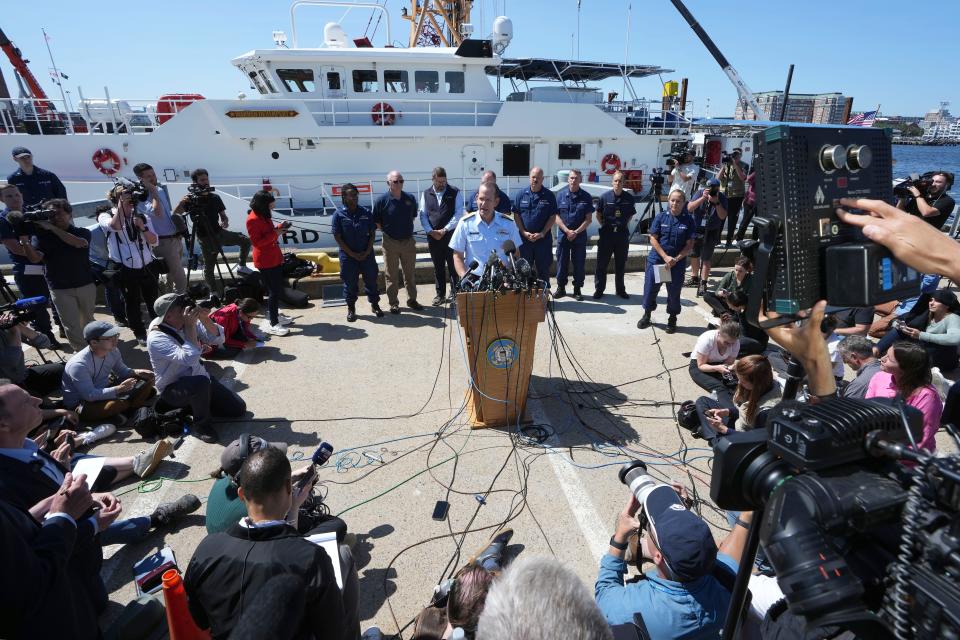 U.S. Coast Guard Rear Adm. John Mauger, commander of the First Coast Guard District, center at microphone, talks to the media Thursday, June 22, 2023, at Coast Guard Base Boston, in Boston. The U.S. Coast Guard says the missing submersible imploded near the wreckage of the Titanic, killing all five people on board. Coast Guard officials said during the news conference that they've notified the families of the crew of the Titan, which has been missing for several days.