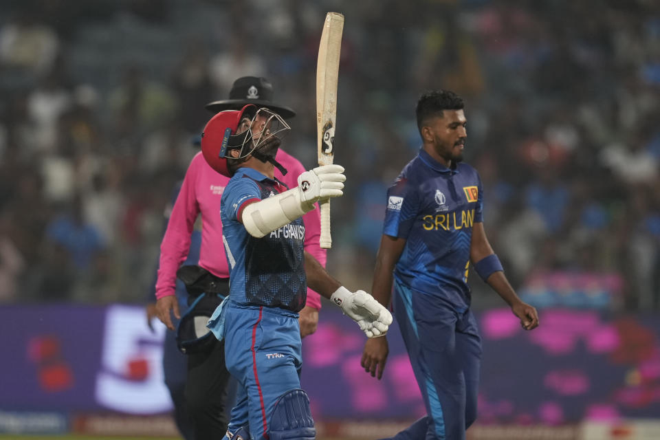 Afghanistan's captain Hashimatullah Shahidi celebrates his fifty runs during the ICC Men's Cricket World Cup match between Sri Lanka and Afghanistan in Pune, India, Monday, Oct. 30, 2023. (AP Photo/Rajanish Kakade)