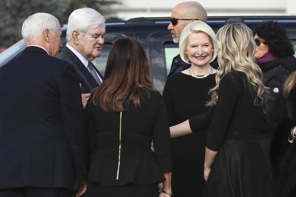 US Vice President Mike Pence, left with back to camera, and his wife Karen, third from left, are welcomed by US Ambassador to the Holy See Callista Gingrich, center and her husband Newt Gingrich, second from left, after disembarking from Air Force Two upon their arrival at Rome's Ciampino airport, Friday, Jan. 24, 2020. Pence is scheduled to meet later with Pope Francis at the Vatican. (AP Photo/Alessandra Tarantino)