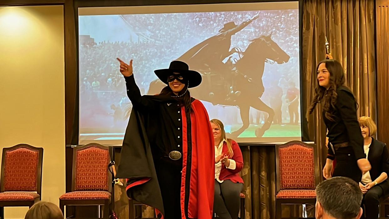 Ellie Brown throwing a Gun's Up for the first time as the 63rd Masked Rider of Texas Tech University at the Transfer of the Reins Ceremony at the McKenzie-Merket Alumni Center on April 19, 2024.