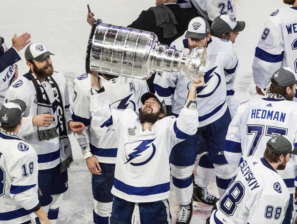 FILE - In this Sept. 28, 2020, file photo, Tampa Bay Lightning's Nikita Kucherov (86) hoists the Stanley Cup after defeating the Dallas Stars in the NHL Stanley Cup hockey finals in Edmonton, Alberta. Kucherov is expected to miss the entire regular season because of a hip injury that requires surgery. General manager Julien BriseBois ruled out Kucherov for the 56-game season that begins Jan. 13 and ends May 8. (Jason Franson/The Canadian Press via AP, File)