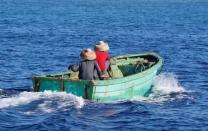 Chinese fishermen steer a dinghy at at the disputed Scarborough Shoal April 5, 2017. Picture taken April 5, 2017. REUTERS/Erik De Castro