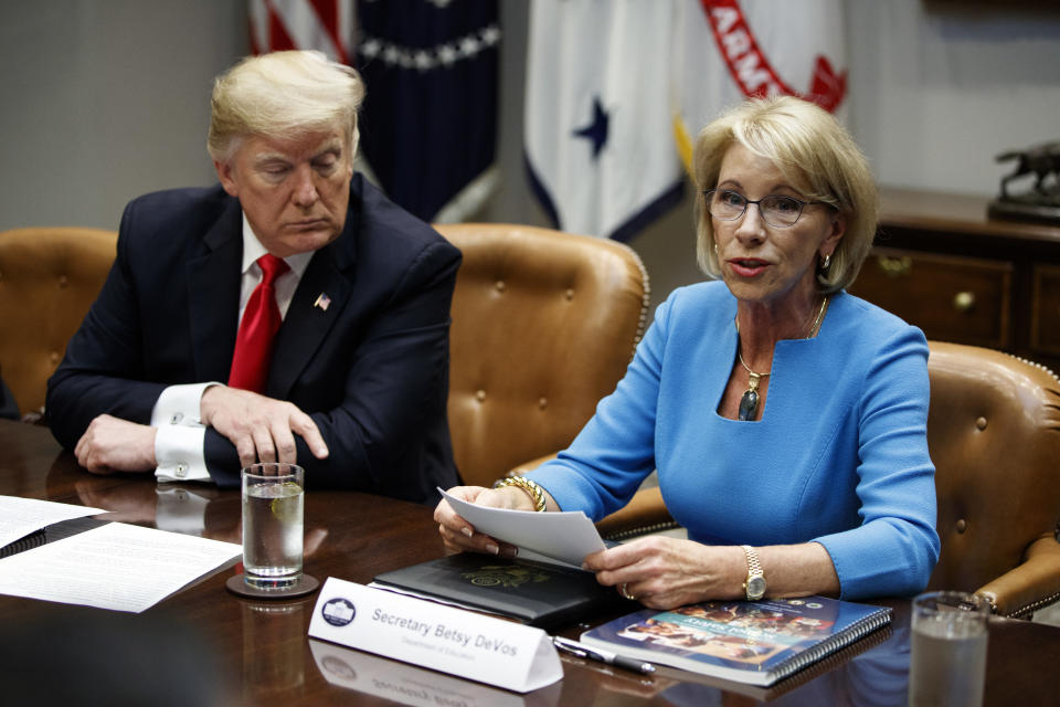 President Donald Trump listens as Secretary of Education Betsy DeVos speaks during a roundtable discussion on the Federal Commission on School Safety report, in the Roosevelt Room of the White House, Tuesday, Dec. 18, 2018, in Washington. (AP Photo/Evan Vucci)