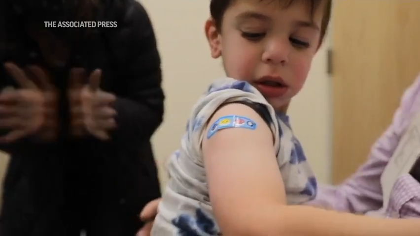 A young child receives a vaccination.